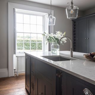 Dark grey-blue kitchen with large window
