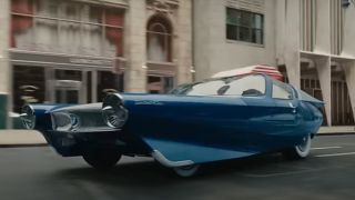 A cool retro car speeding through the streets in The Fantastic Four: First Steps