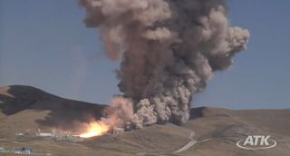This still from an ATK webcast shows a wide view of the five-segment solid rocket booster DM3 during a Sept. 8, 2011 static test firing at the company's motor proving grounds near Promontory, Utah.