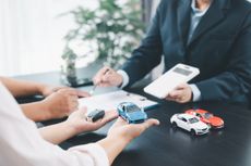 Businessman explaining car loan agreement with customer