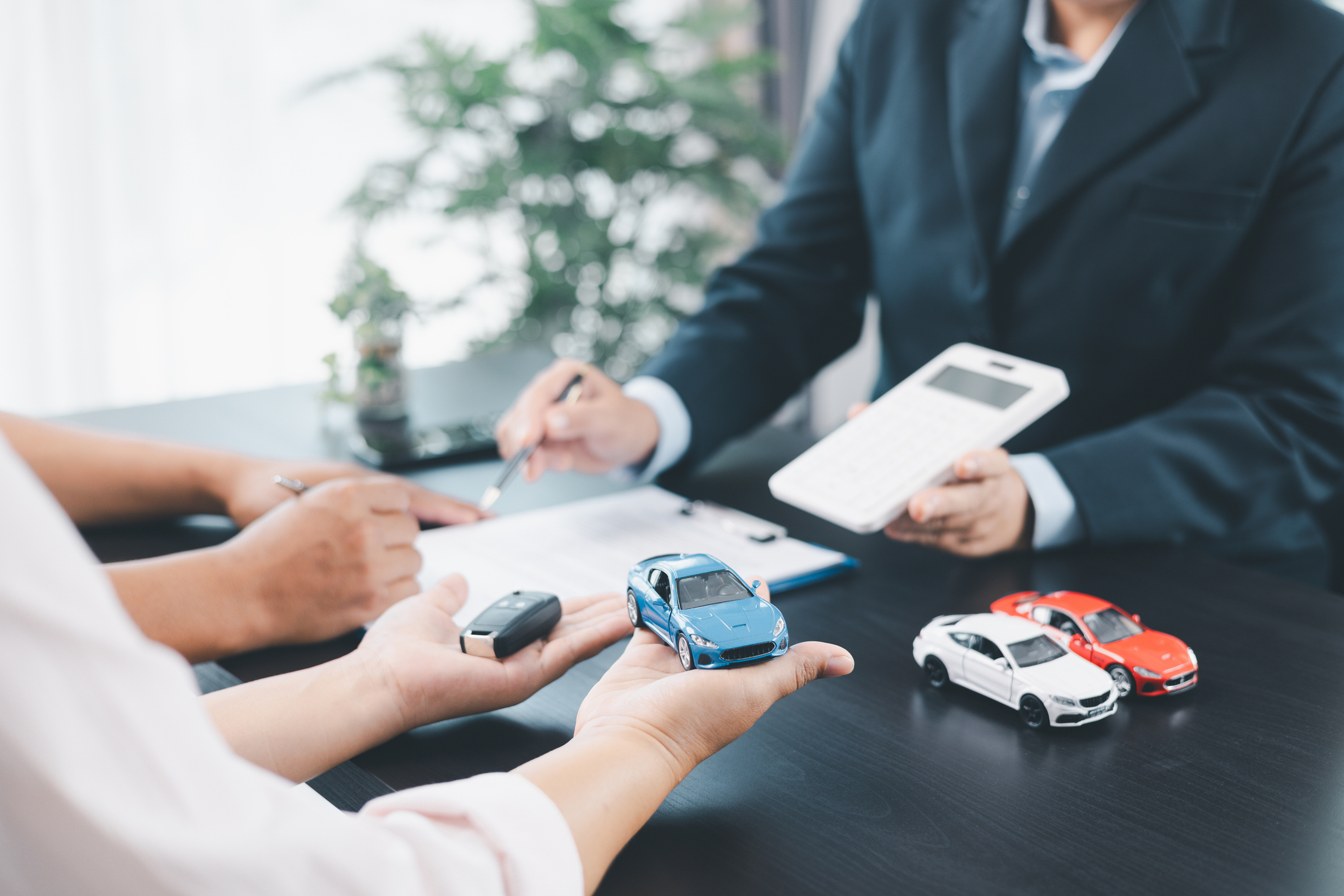 Businessman explaining car loan agreement with customer