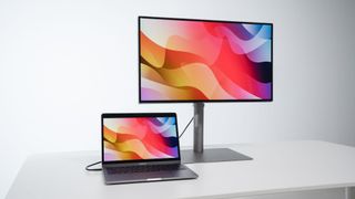 BenQ PD3220U monitor paired with a MacBook in M-Book Mode.