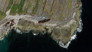 An aerial view of a shipwreck on land