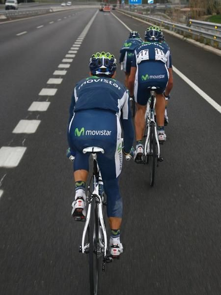Movistar teammates drop back to assist their team leader Alejandro Valverde.