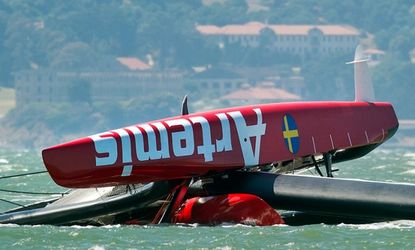 The Artemis Racing AC72 catamaran, an America's Cup yacht from Sweden, lies capsized after flipping over in the San Francisco Bay, May 9.
