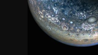 closeup of jupiter and its swirling clouds against the blackness of space