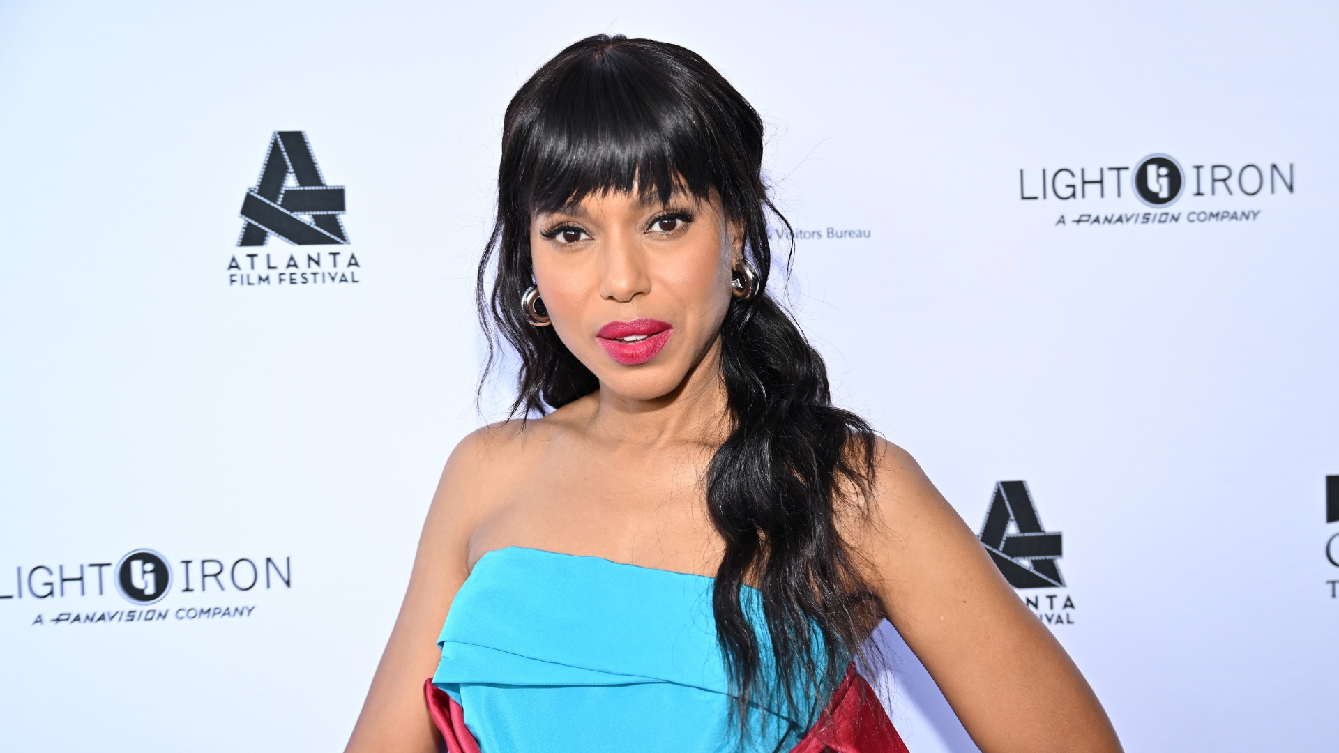 Kerry Washington is pictured wearing a blue and pink dress, paired with bright berry-red lipstick look whilst attending the "Shadow Force" Marquee Presentation during the 2025 Annual Atlanta Film Festival at Plaza Theatre on April 27, 2025 in Atlanta, Georgia.
