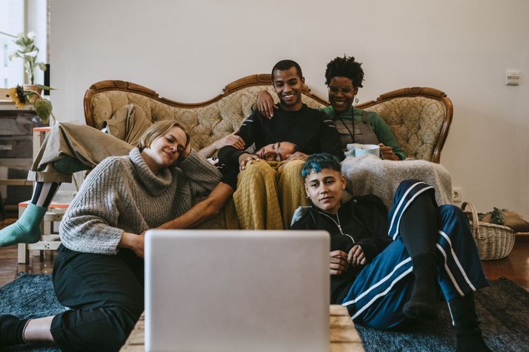 Group of people watching movie on laptop in living room