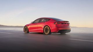 Tesla model s in red render on open road