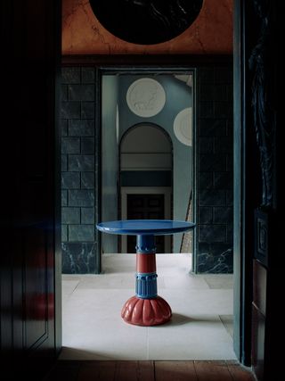The Ropley occasional table, made of blue and burgundy clay formed fired ceramic faience