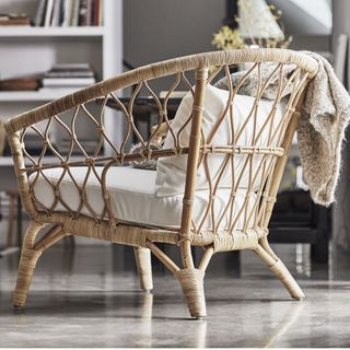 wooden armchair with white cushions