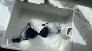 A bra inside a basin of cold water used to demonstrate how to wash a bra