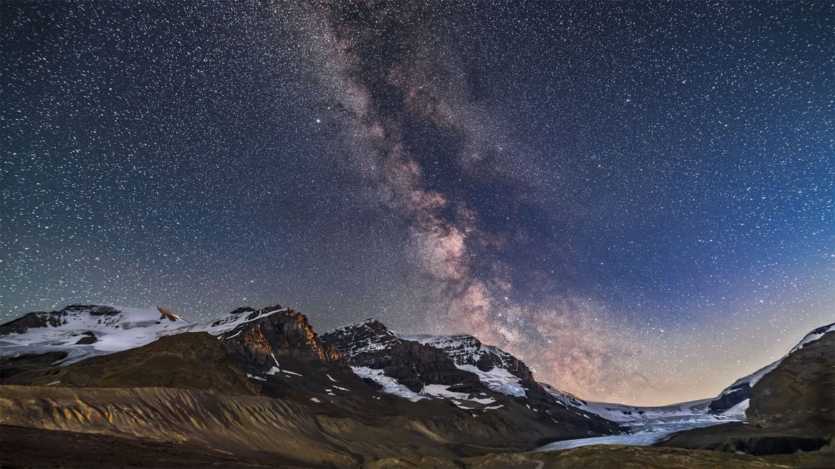 The milky way galaxy as seen over a mountain range.