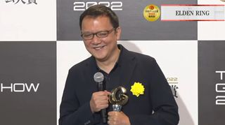 FromSoftware president Hidetaka Miyazaki smiles while holding Grand Award from the Tokyo Game Show's Japanese Game Awards