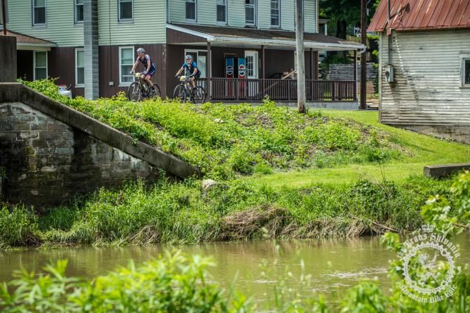 Two riders roll through Coburn, PA during stage 4 of the Trans-Sylvania Epic