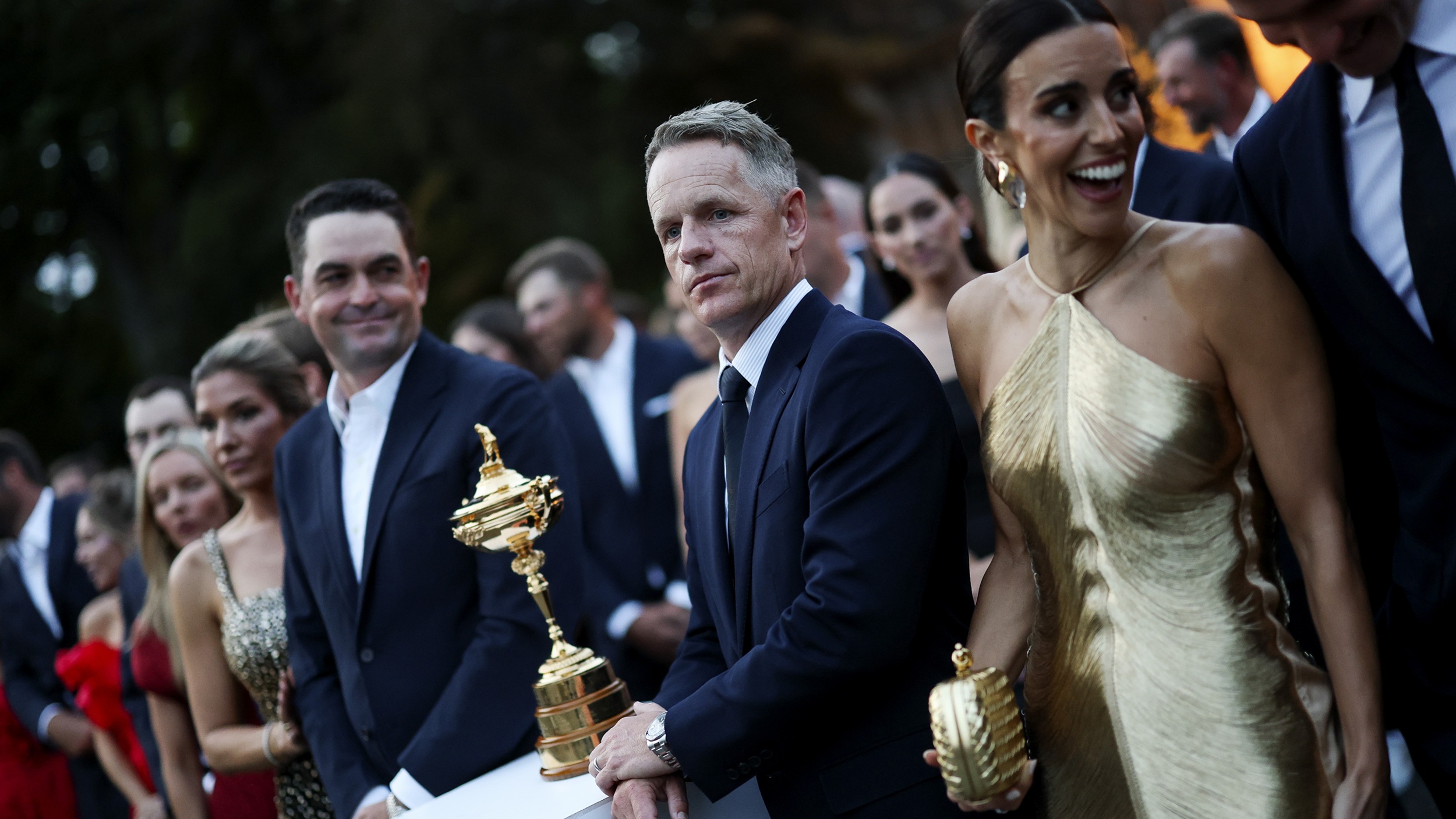 Luke Donald and wife Diane pose alongside the Ryder Cup and Keegan Bradley in New York