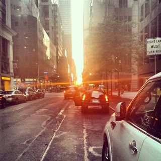 Lou Barber's Manhattanhenge photo shows the setting sun illuminating the city streets.