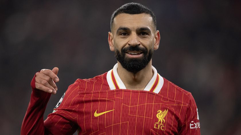 A close-up shot of Mo Salah of Liverpool FC smiling during a Champions League match