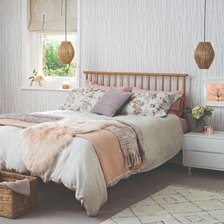Pink and grey bedding on a wooden bed