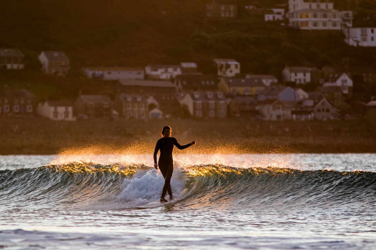 Izzy Henshall surfing at Sennen