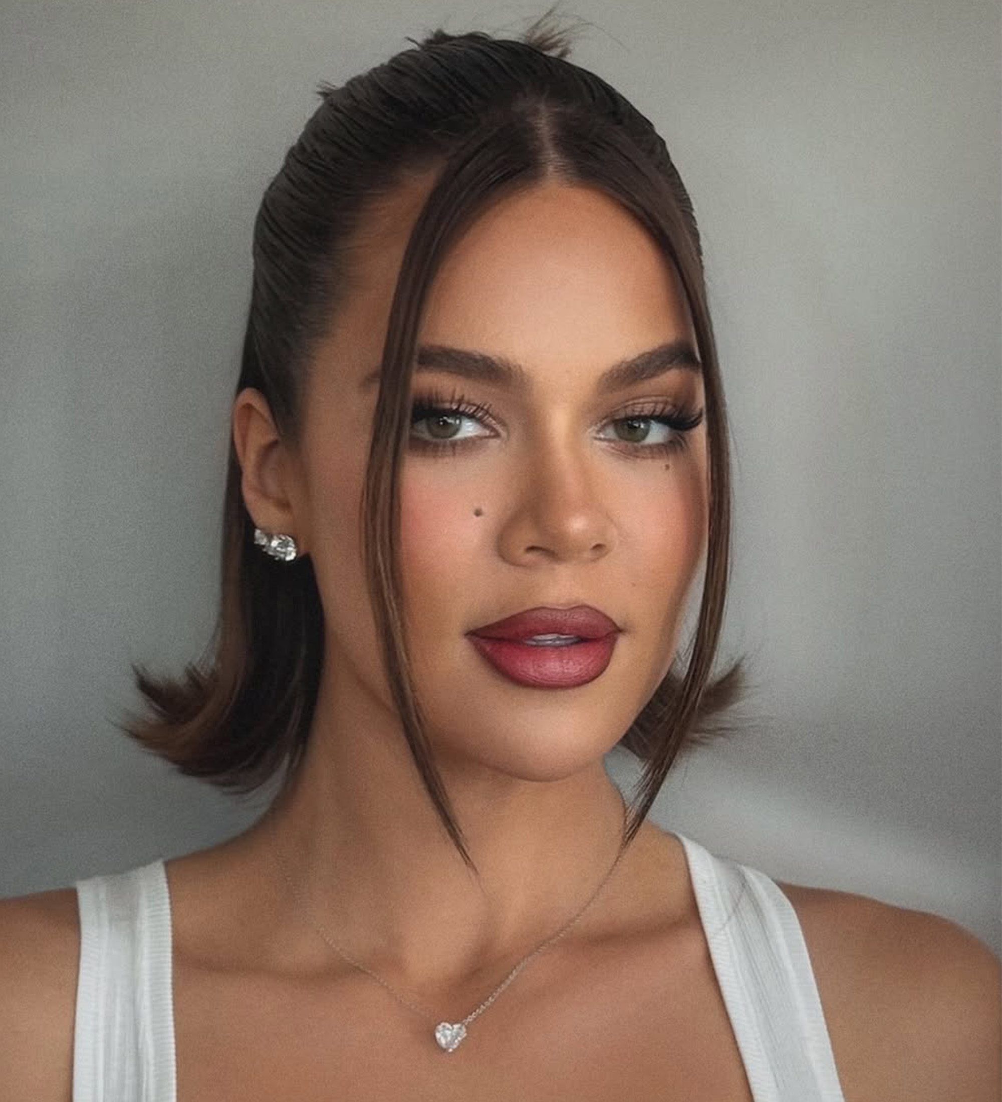 A half-up half down flipped bob on Khloe Kardashian by Justine Marjan.
