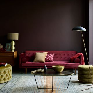 room with red sofa floor lamp and cushions