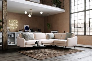 apartment living room with cream sectional, side board with neon sign, recored player, mezzanine floor, rug, wooden floor