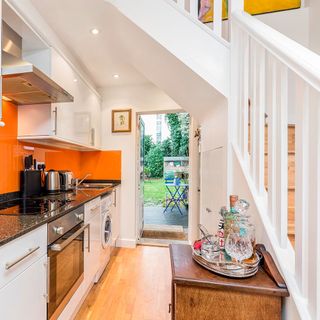 attic kitchen with white wall and stairs