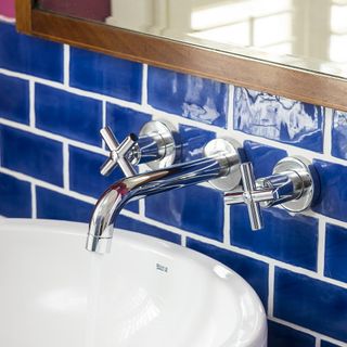 wash basin with blue brick tile wall