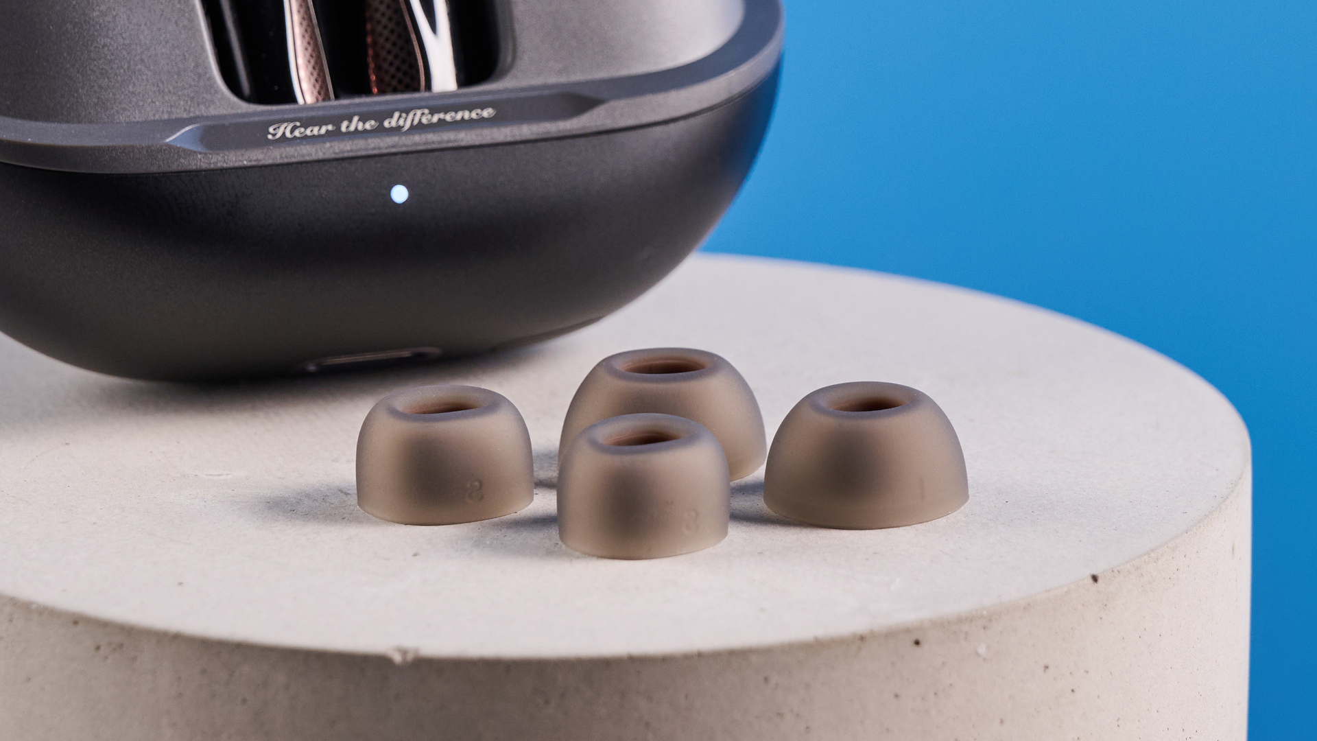 the soundpeats air5 pro earbuds in black and bronze with a black charging case and ear tips