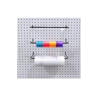 A pegboard with three holders on it