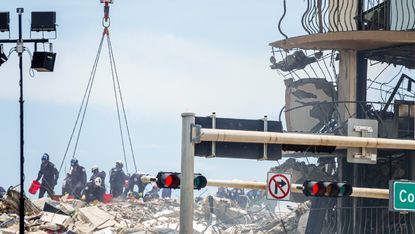 First responders searching debris for signs of life