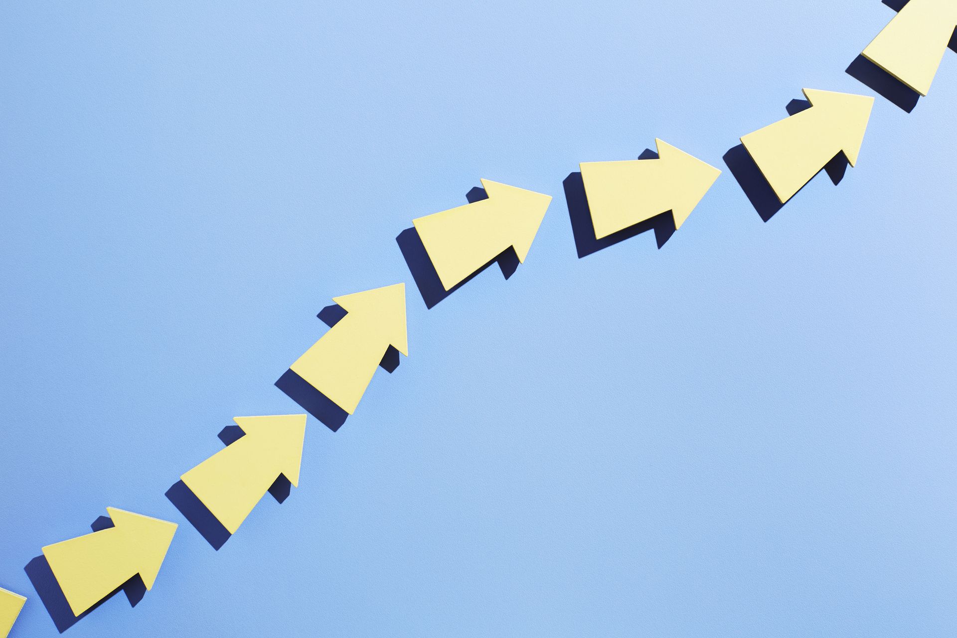 A group of arrows moving up together in a line