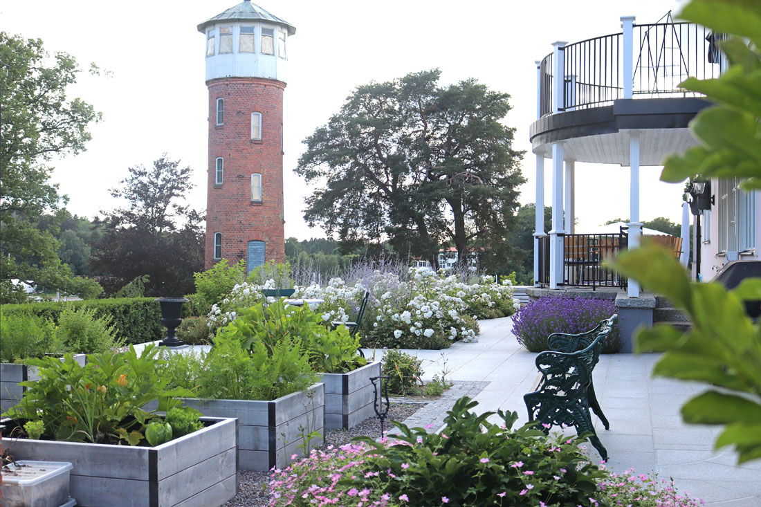 planted outdoor area with a lighthouse in the back