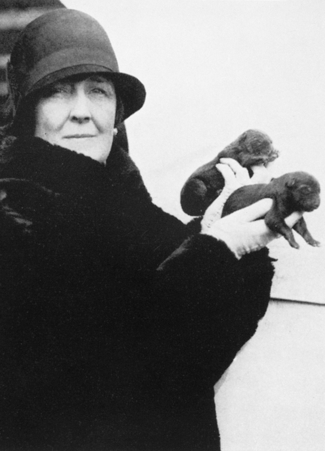 Carrie Phillips holding a pair of puppies