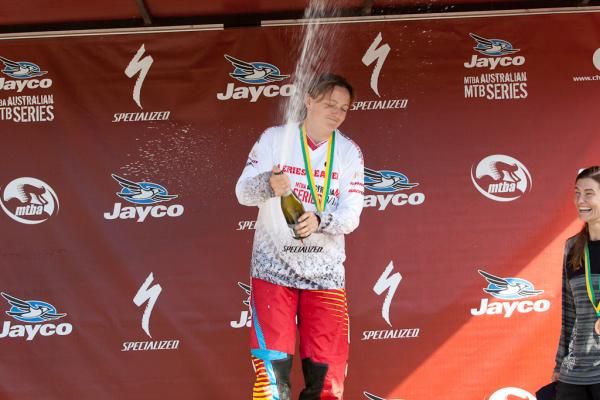 Women's winner Leonie Picton (Yarra Valley Cycles) opens the champagne