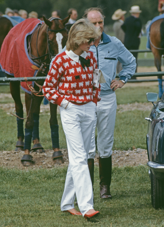 Diana, Princess of Wales (1961 - 1997) with Major Ronald Ferguson (1931 - 2003) at a polo match at Smith's Lawn, Guards Polo Club, Windsor, June 1983. Diana is wearing a Muir and Osborne 'black sheep' sweater