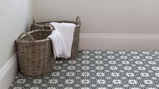 vinyl flooring bathroom with two wicker baskets with towels