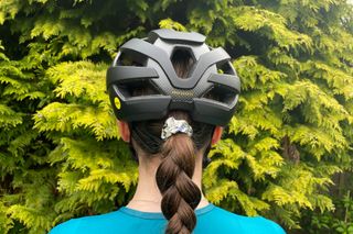 Female cyclist wearing the Trek Velocis MIPS road bike helmet