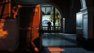 007 First Light screenshot showing James Bond crouched behind boxes in stealth