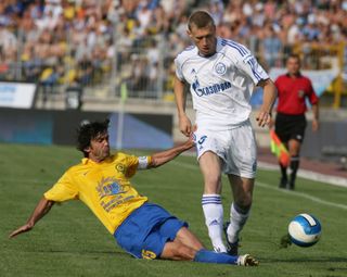 Luch Vladivostok captain Beslan Ajinjal tackles Zenit Saint Peterseburg's Pavel Pogrebyank during a 2007 Russian Premier League match in Saint Petersburg