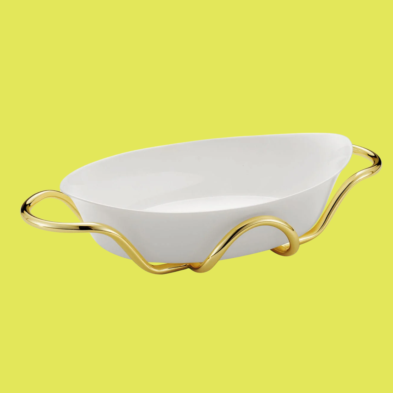 A white ceramic oval baking dish with gold handles from Bragagnolo Argenti, against a lime yellow background