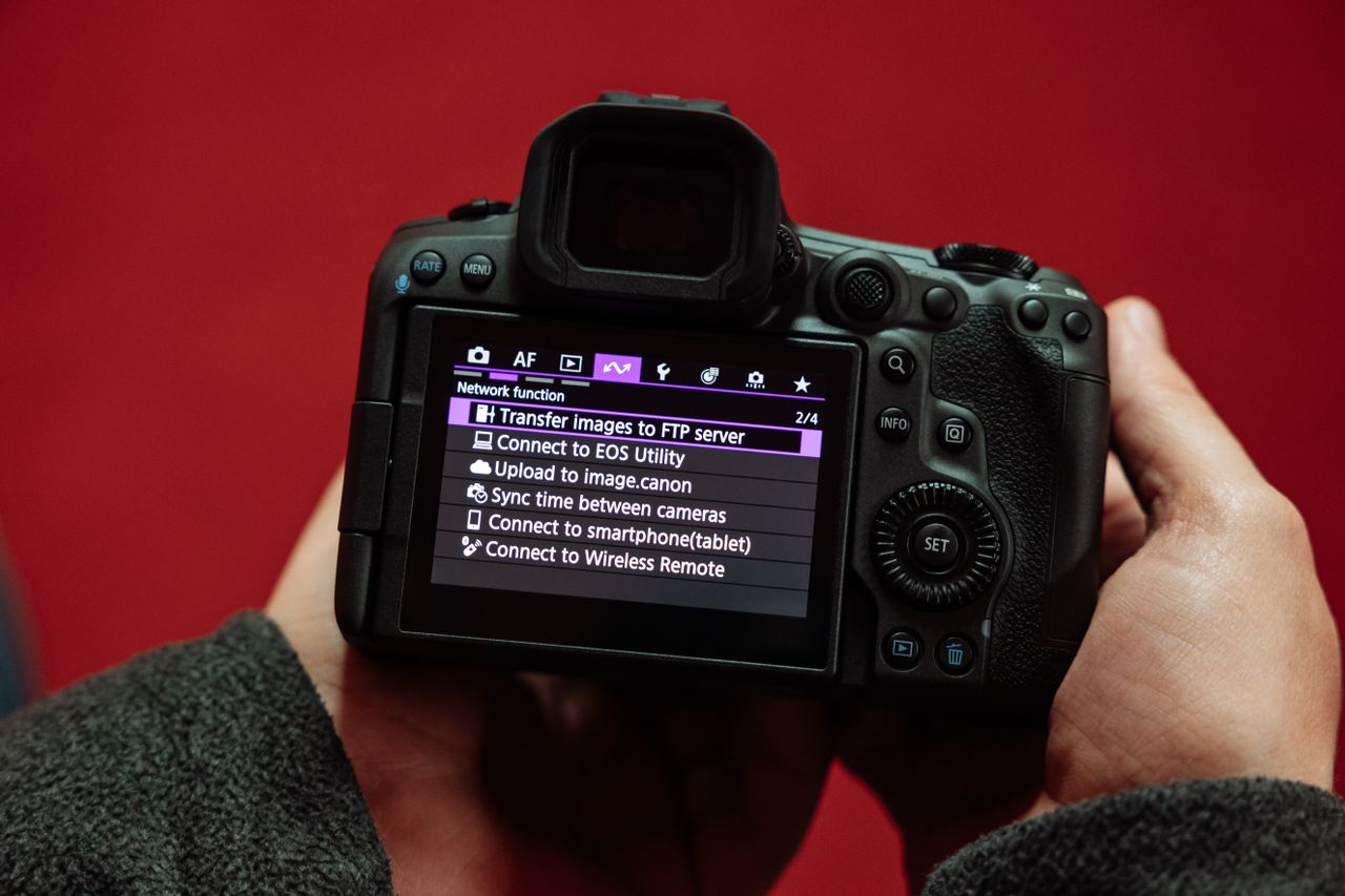 Two hands holding the Canon EOS R5 Mark II