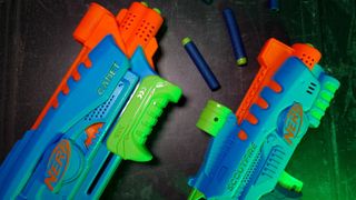 Nerf Elite Jr. Starter Set blasters laid out beside one another, with darts, on a dark backdrop