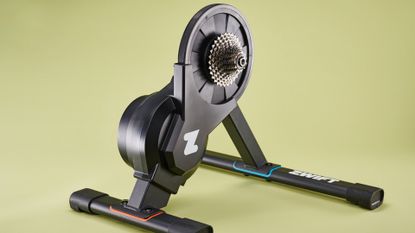 The Zwift Hub turbo trainer on a yellow background