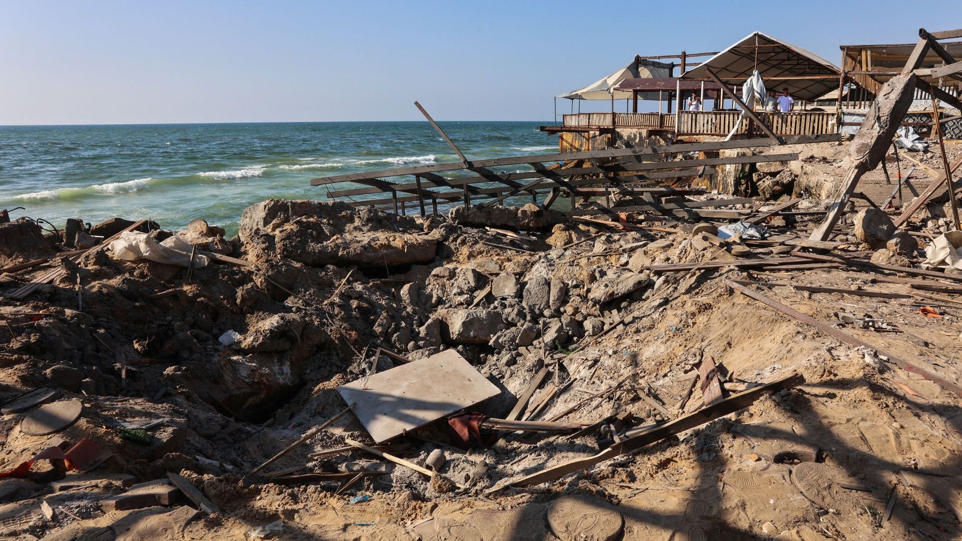 
                                A crater remains where the Al-Baqa Cafeteria once stood, following an Israeli airstrike on Gaza&#039;s seafront
                            