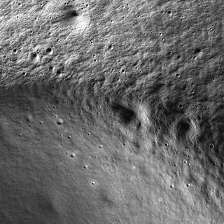 The moon's surface as seen by ShadowCam illuminated by sunlight reflected off nearby geologic features such as mountains and crater walls.