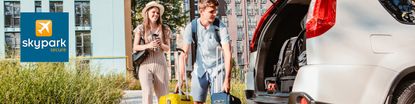 Couple at the airport with their bags going to load the car in the sky park secure parking