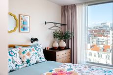 a bedroom in lisbon with floral patterned bedding and a chest of drawers
