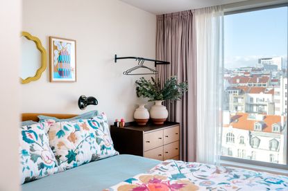 a bedroom in lisbon with floral patterned bedding and a chest of drawers